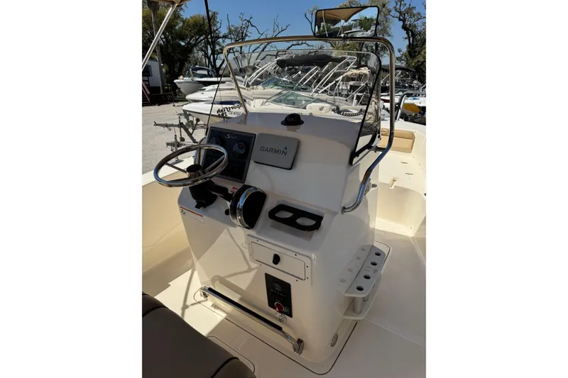 Slide: The Image of 2018 Scout 195 Sportfish boat console with steering wheel and Garmin navigation system. - 17