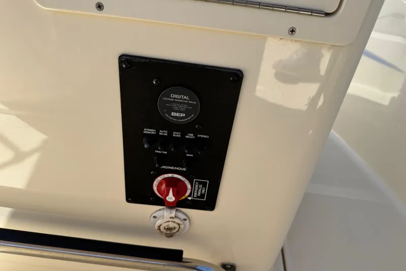 Slide: The Image of Control panel on a 2018 Scout 195 Sportfish boat, featuring digital relay and emergency switch. - 19