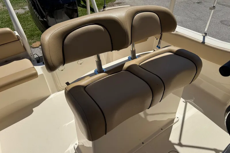 Slide: The Image of 2018 Scout 195 Sportfish boat with tan cushioned seating in sunlight. - 27