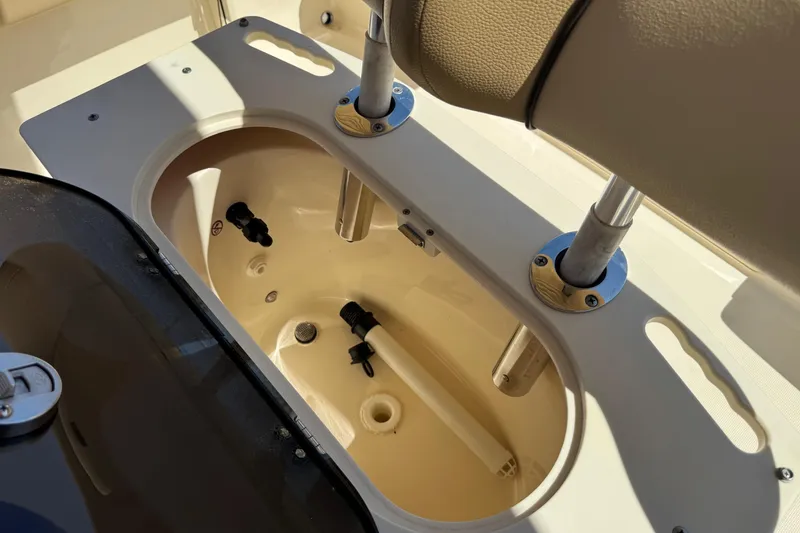 Slide: The Image of Livewell compartment on a 2018 Scout 195 Sportfish boat, featuring rod holders. - 29