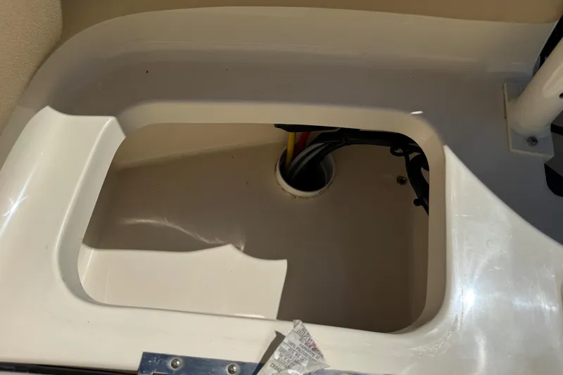 Slide: The Image of 2018 Scout 195 Sportfish boat compartment with wiring visible. - 30