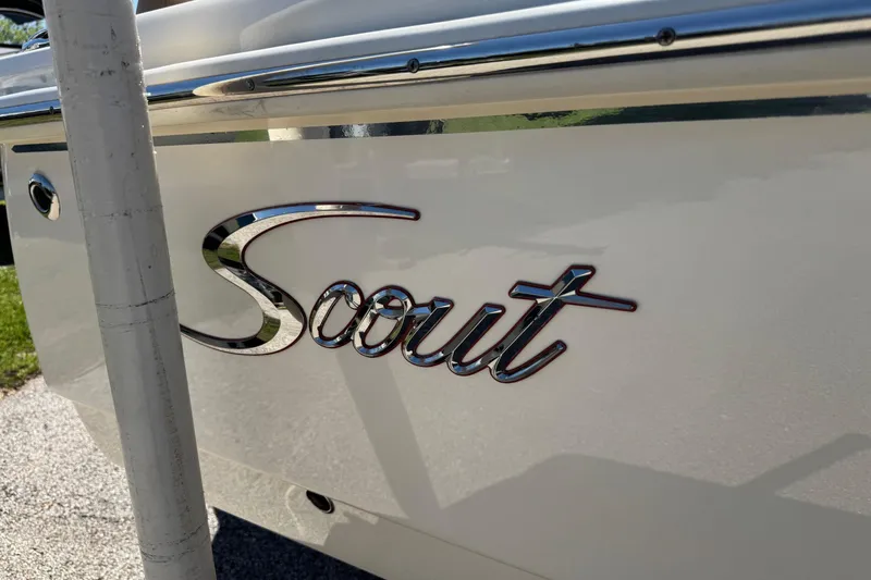 Slide: The Image of 2018 Scout 195 Sportfish boat logo on white hull, close-up view. - 4