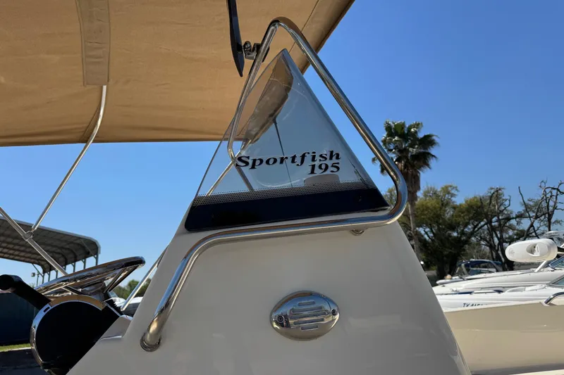 Slide: The Image of 2018 Scout 195 Sportfish boat detail with steering wheel and canopy. - 5