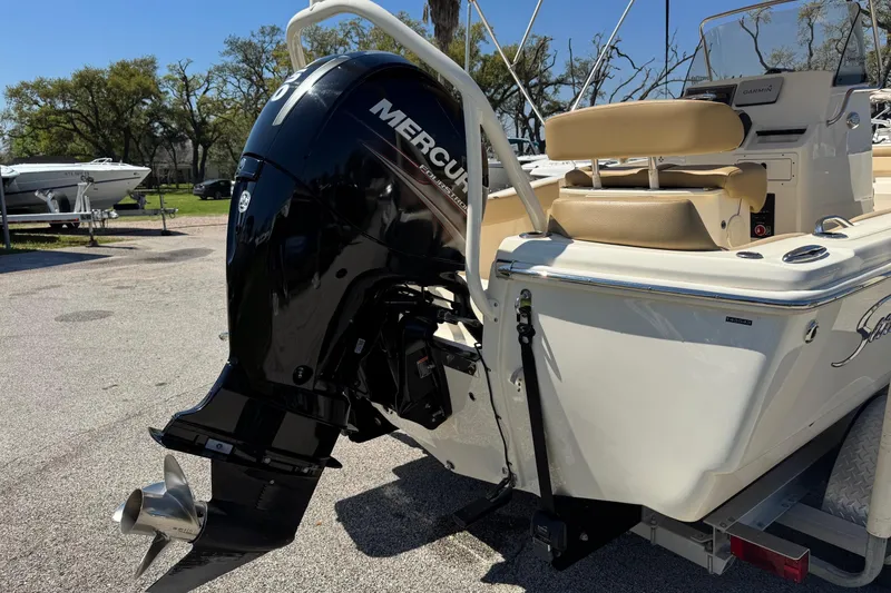 Slide: The Image of 2018 Scout 195 Sportfish boat with Mercury outboard motor, parked on a trailer. - 6