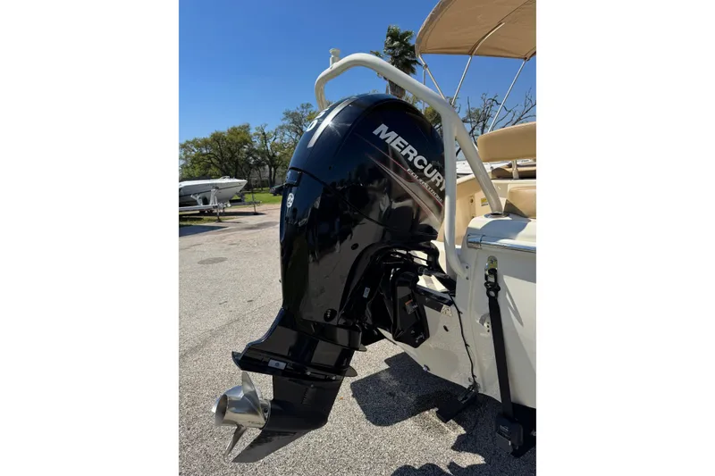 Slide: The Image of 2018 Scout 195 Sportfish boat with Mercury outboard motor in sunny outdoor setting. - 7