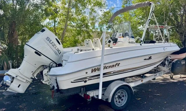 The Image of 2003 Wellcraft Tournament boat with Suzuki outboard motor on trailer. - 0