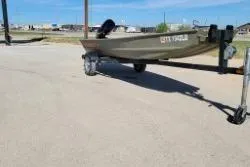 Slide: The Image of 2025 Tracker Grizzly 1436 Utility boat on trailer in outdoor setting. - 4