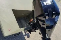 Slide: The Image of 2025 Tracker Grizzly 1436 Utility boat with 15 HP outboard motor, rear view. - 6