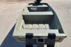 Slide: The Image of 2025 Tracker Grizzly 1436 Utility boat, empty interior view, on a sunny day. - 7