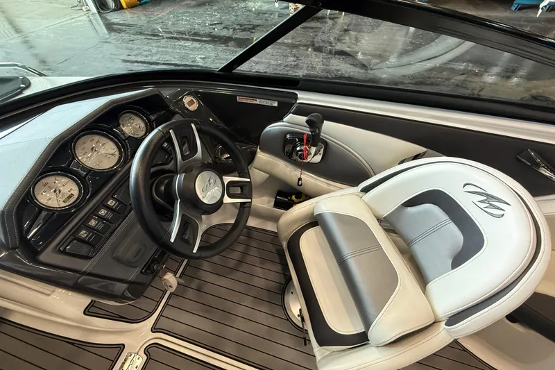 Slide: The Image of 2016 Monterey 224FS boat cockpit with steering wheel and gauges, featuring sleek design and comfortable seating. - 12