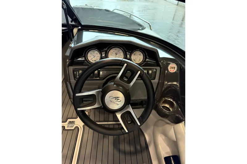 Slide: The Image of Steering wheel and dashboard of 2016 Monterey 224FS boat, featuring gauges and controls. - 13