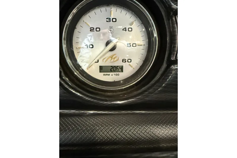 Slide: The Image of Close-up of a 2016 Monterey 224FS tachometer displaying 2064 RPM. - 14