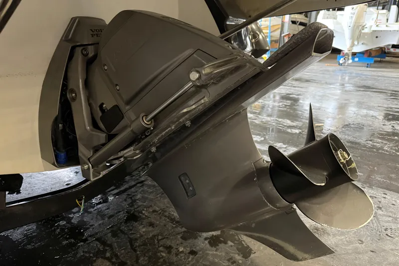 Slide: The Image of Close-up of a 2016 Monterey 224FS boat's propeller and outdrive in a garage setting. - 17