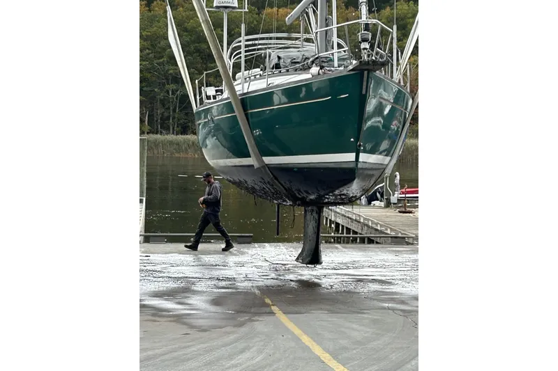 The Image of Sailboat Beneteau Oceanis 381, 1999 model, being lifted at a marina dock. - 0
