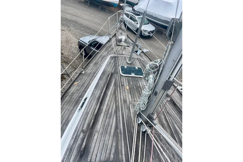 Slide: The Image of Deck view of a 1999 Beneteau Oceanis 381 sailboat, showcasing rigging and wood finish. - 14