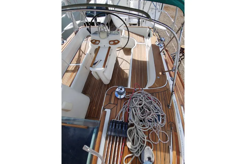 Slide: The Image of Cockpit view of 1999 Beneteau Oceanis 381 sailboat with teak decking and steering wheel. - 4