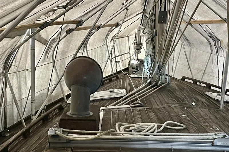 Slide: The Image of Covered deck of a 1999 Beneteau Oceanis 381 sailboat with rigging and ropes. - 6