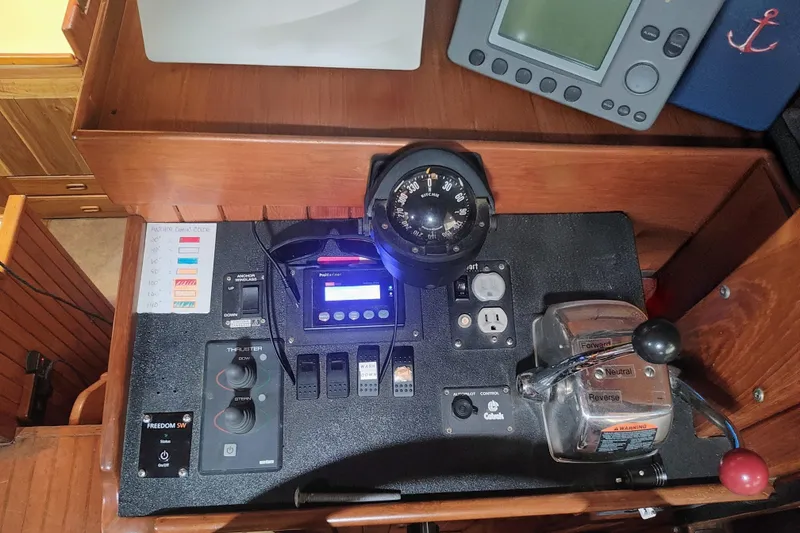 Slide: The Image of Control panel of a 1986 CHB Senator boat with navigation instruments and throttle controls. - 24