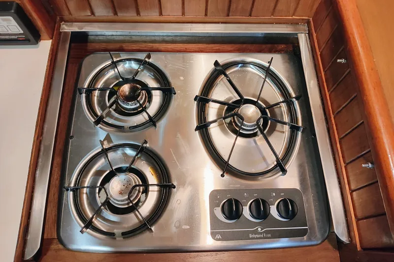 Slide: The Image of Three-burner stainless steel stove in a 1986 CHB Senator boat kitchen. - 38