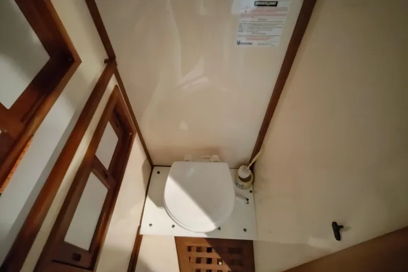 Slide: The Image of 1986 CHB Senator boat bathroom with wooden accents and compact toilet design. - 44
