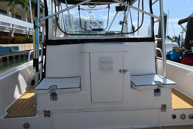 Slide: The Image of 1992 Luhrs 300 Tournament boat interior with seating and storage, docked at marina. - 22