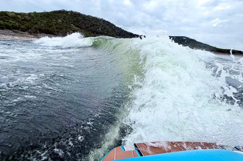 Slide: The Image of Wakesurfing wave behind 2023 Malibu Wakesetter 23 MXZ on a scenic lake. - 12