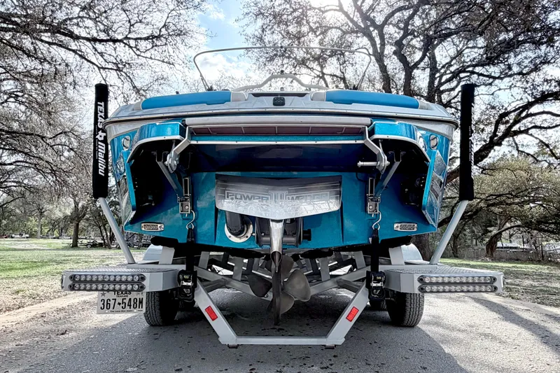 Slide: The Image of 2023 Malibu Wakesetter 23 MXZ boat on trailer, rear view, parked outdoors. - 17