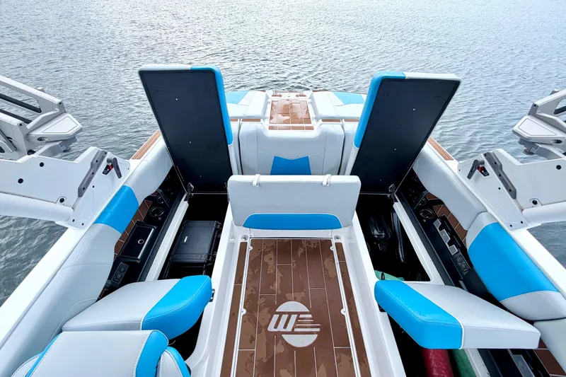 Slide: The Image of 2023 Malibu Wakesetter 23 MXZ interior with blue and white seating on water. - 32