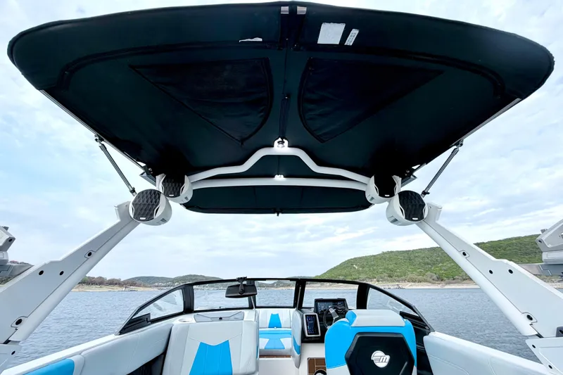 Slide: The Image of 2023 Malibu Wakesetter 23 MXZ boat interior with canopy and lake view. - 35