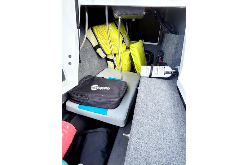 Slide: The Image of Storage compartment of 2023 Malibu Wakesetter 23 MXZ with safety gear and equipment. - 41