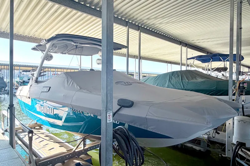 Slide: The Image of 2023 Malibu Wakesetter 23 MXZ covered and docked in a marina. - 43