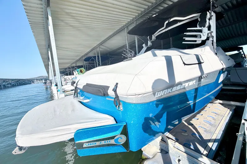 Slide: The Image of 2023 Malibu Wakesetter 23 MXZ boat docked under a covered marina. - 44
