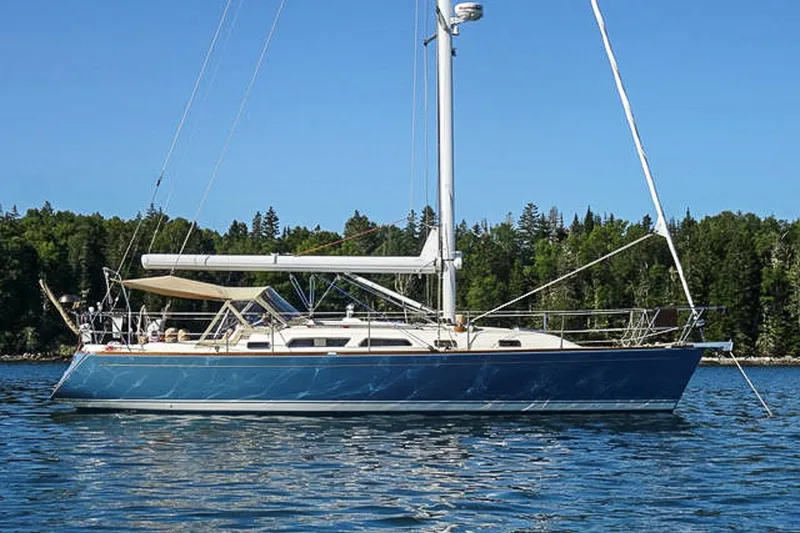 The Image of 2007 Sabre 386 sailboat on calm water with forested shoreline background. - 1
