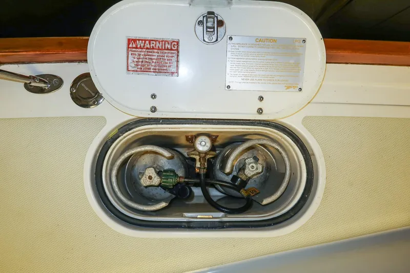 Slide: The Image of LPG compartment on a 2007 Sabre 386 boat with safety warnings. - 13