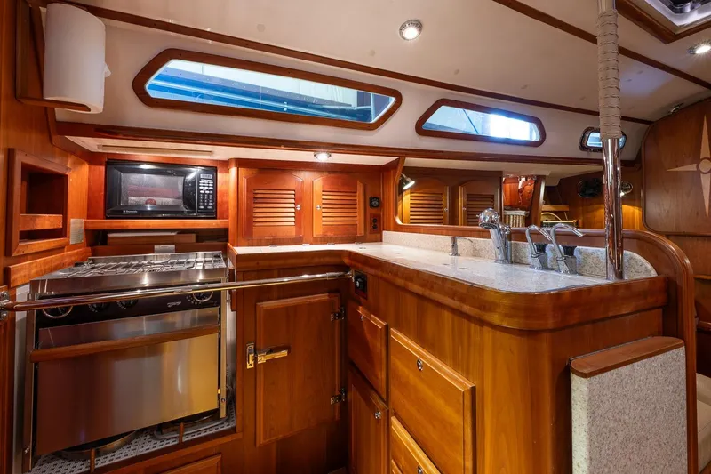 Slide: The Image of Luxurious 2007 Sabre 386 yacht kitchen with wood cabinetry and modern appliances. - 20