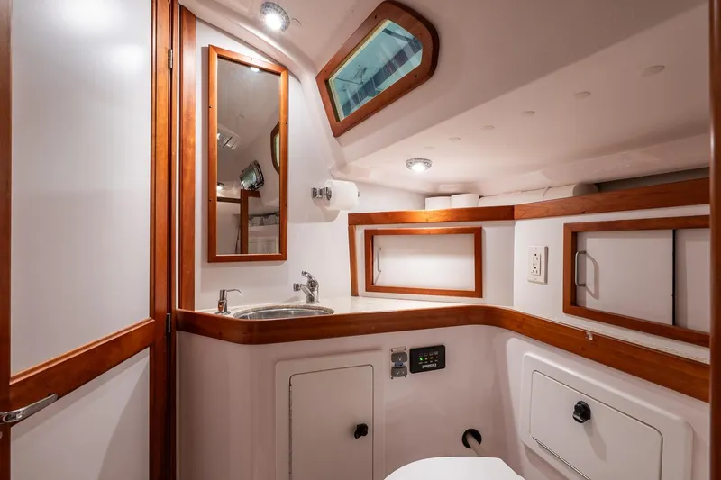 Slide: The Image of 2007 Sabre 386 yacht bathroom with wooden accents and modern fixtures. - 23
