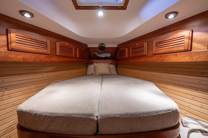 Slide: The Image of Luxurious cabin interior of 2007 Sabre 386 yacht with cozy bedding and wooden accents. - 30