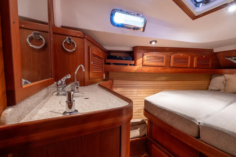 Slide: The Image of Luxurious 2007 Sabre 386 yacht cabin with wooden interior and cozy bed. - 32