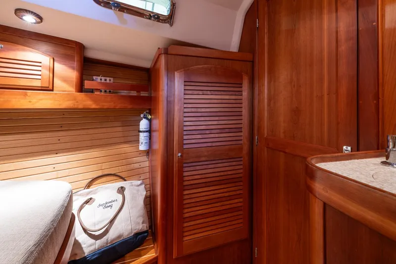 Slide: The Image of Interior of 2007 Sabre 386 yacht with wooden cabinetry and cozy sleeping area. - 33
