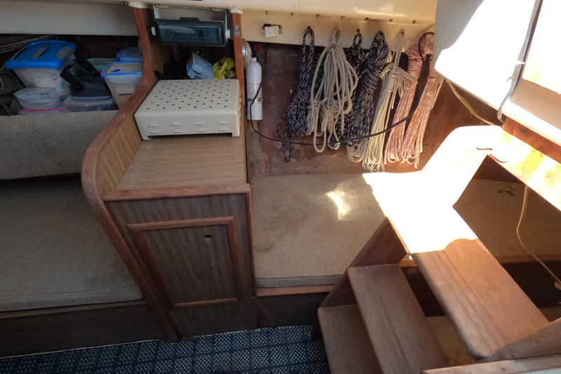 Slide: The Image of Interior of a 1972 Morgan 27 sailboat with ropes and storage compartments. - 11