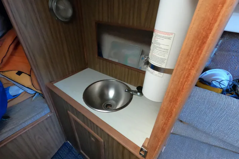 Slide: The Image of 1972 Morgan 27 yacht interior with compact sink and storage area. - 14