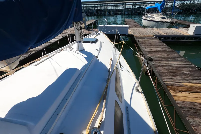 Slide: The Image of 1972 Morgan 27 sailboat docked at marina with wooden piers. - 18