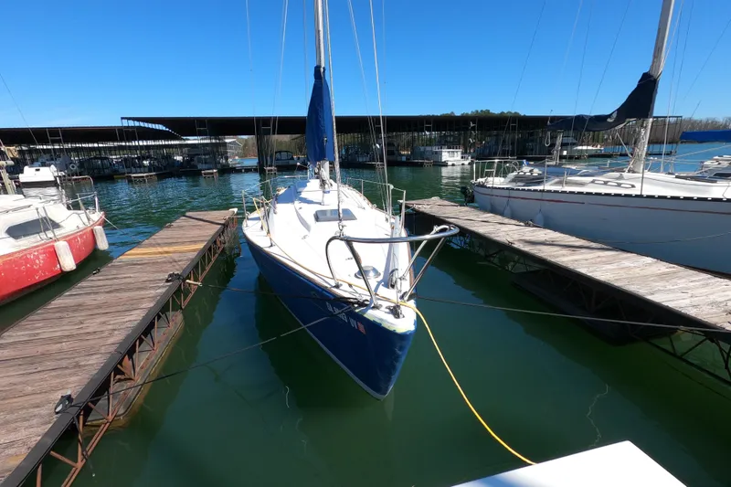 Slide: The Image of 1972 Morgan 27 sailboat docked at a marina under clear blue skies. - 19