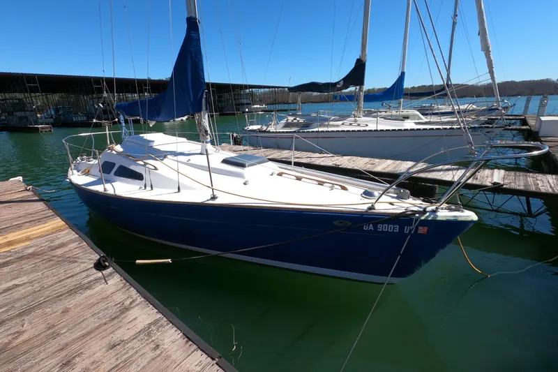 Slide: The Image of 1972 Morgan 27 sailboat docked at marina, featuring blue hull and white deck. - 3