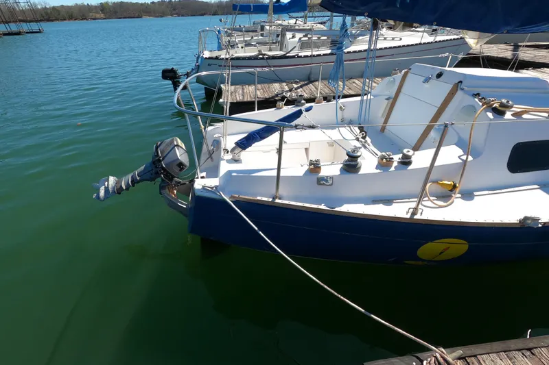 Slide: The Image of 1972 Morgan 27 sailboat docked on calm water, featuring a blue and white design. - 5