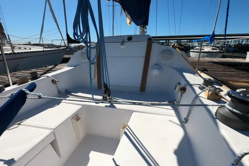 Slide: The Image of 1972 Morgan 27 sailboat cockpit with ropes and winches at a marina. - 7
