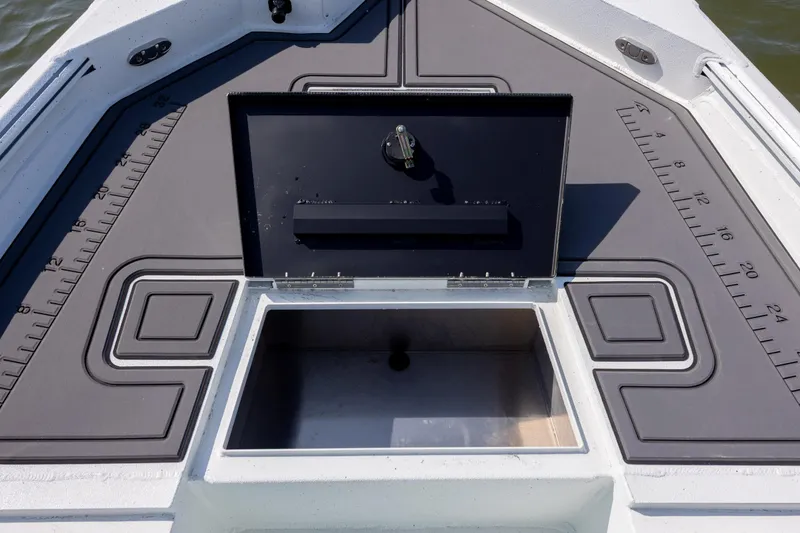 Slide: The Image of 2026 Excel 203 Bay Pro Elite boat deck with open storage compartment and measurement markings. - 11