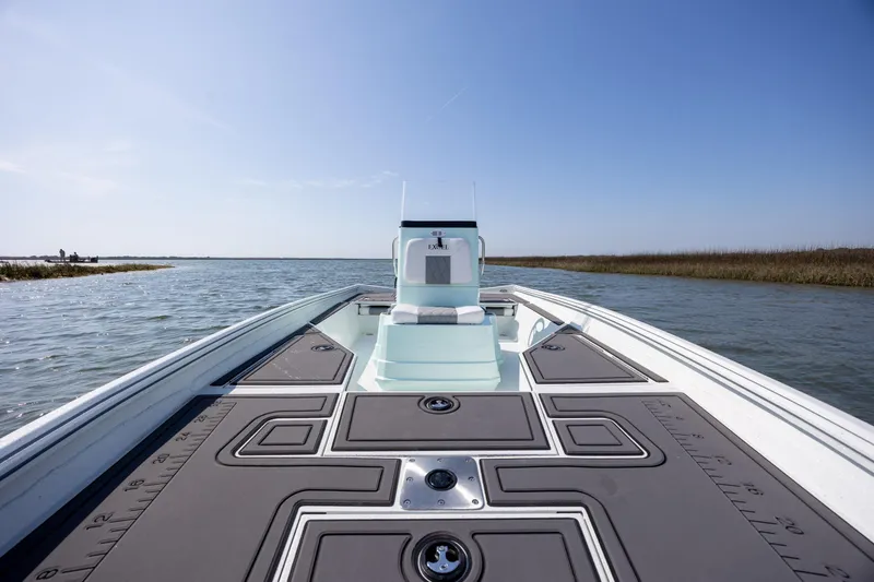 Slide: The Image of 2026 Excel 203 Bay Pro Elite boat on calm water, showcasing spacious deck and sleek design. - 15