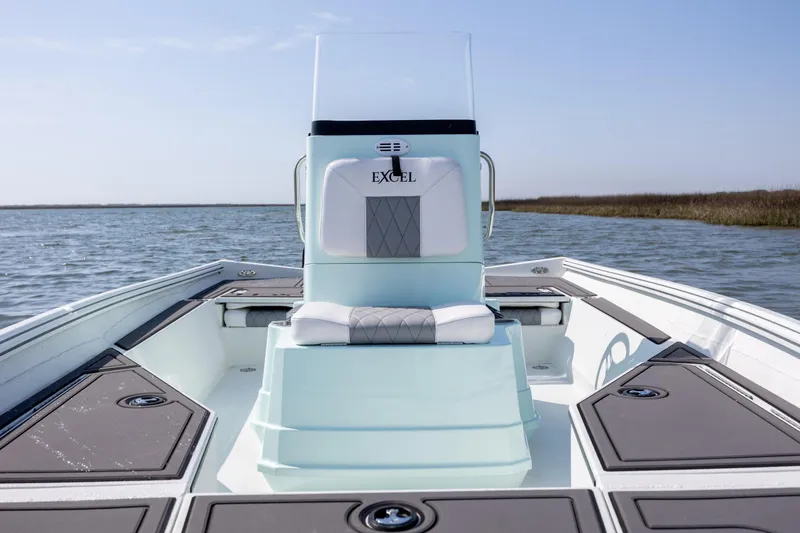 Slide: The Image of 2026 Excel 203 Bay Pro Elite boat on calm water, showcasing sleek design and seating. - 16
