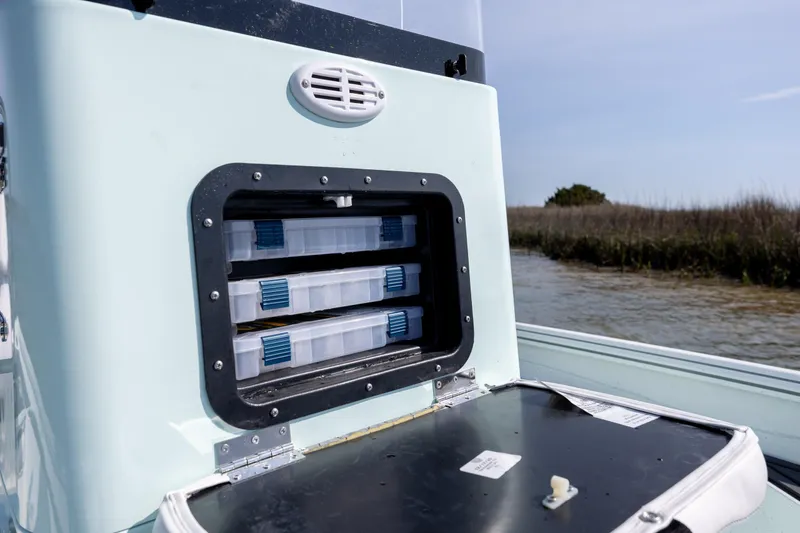 Slide: The Image of Storage compartment on 2026 Excel 203 Bay Pro Elite boat, featuring organized tackle boxes. - 17